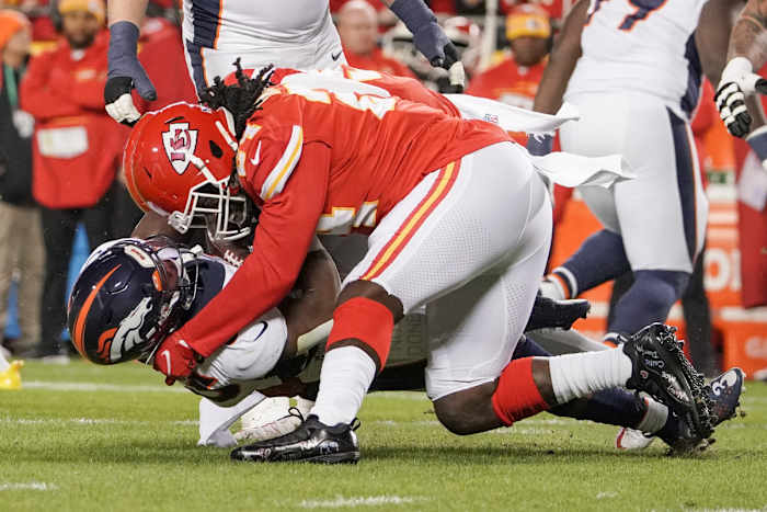 Dec 5, 2021; Kansas City, Missouri, USA; Denver Broncos quarterback Teddy Bridgewater (5) is sacked by Kansas City Chiefs defensive end Melvin Ingram (24) during the game at GEHA Field at Arrowhead Stadium. Mandatory Credit: Denny Medley-USA TODAY Sports